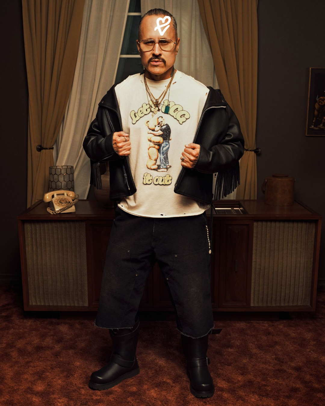 Danny Trejo, UGG × Willy Chavarria kampanyasında siyah deri biker görünümü ve koleksiyondaki UGG botlarıyla.